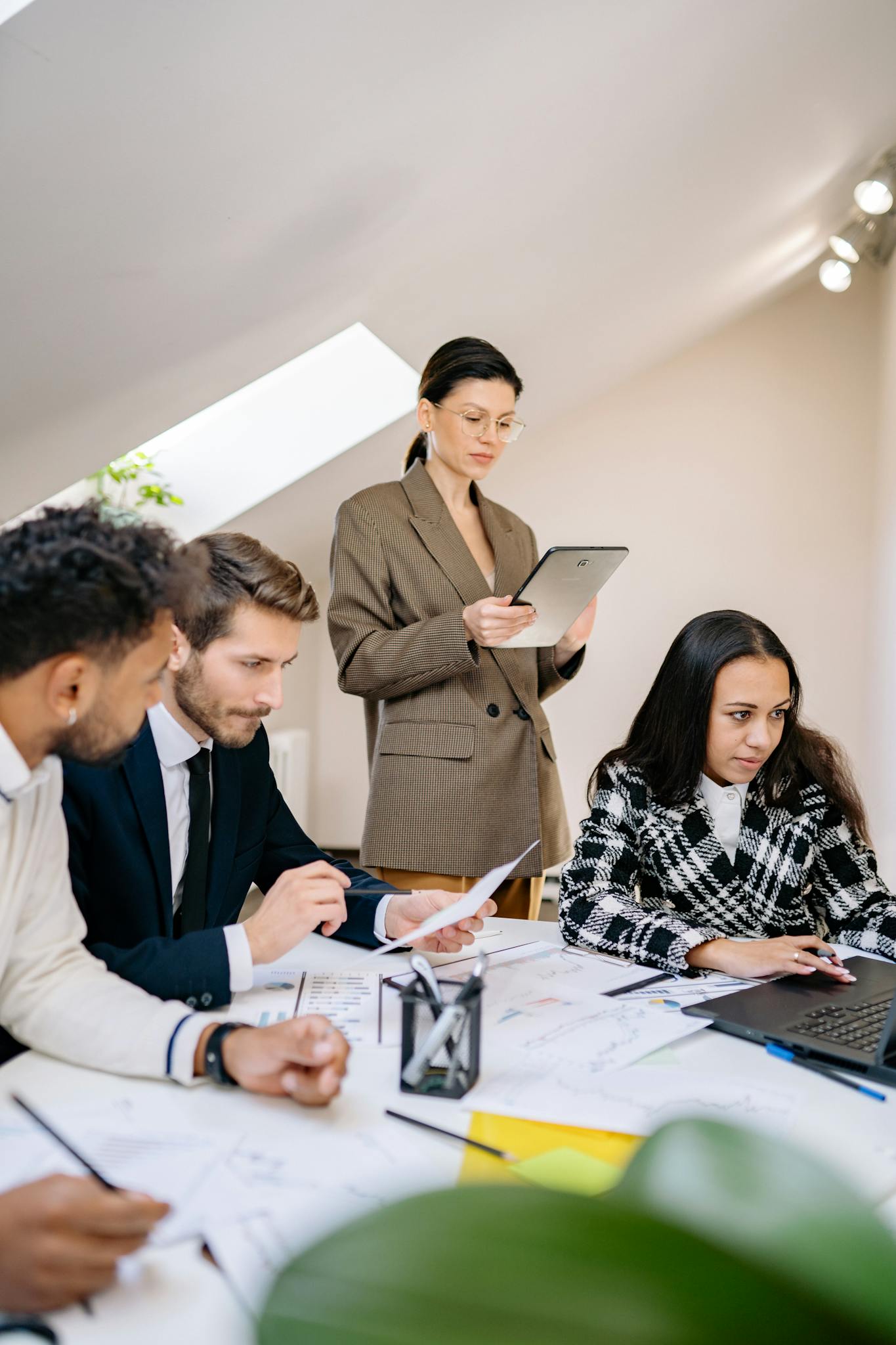A diverse team working together in a bright office space, collaborating on a project.